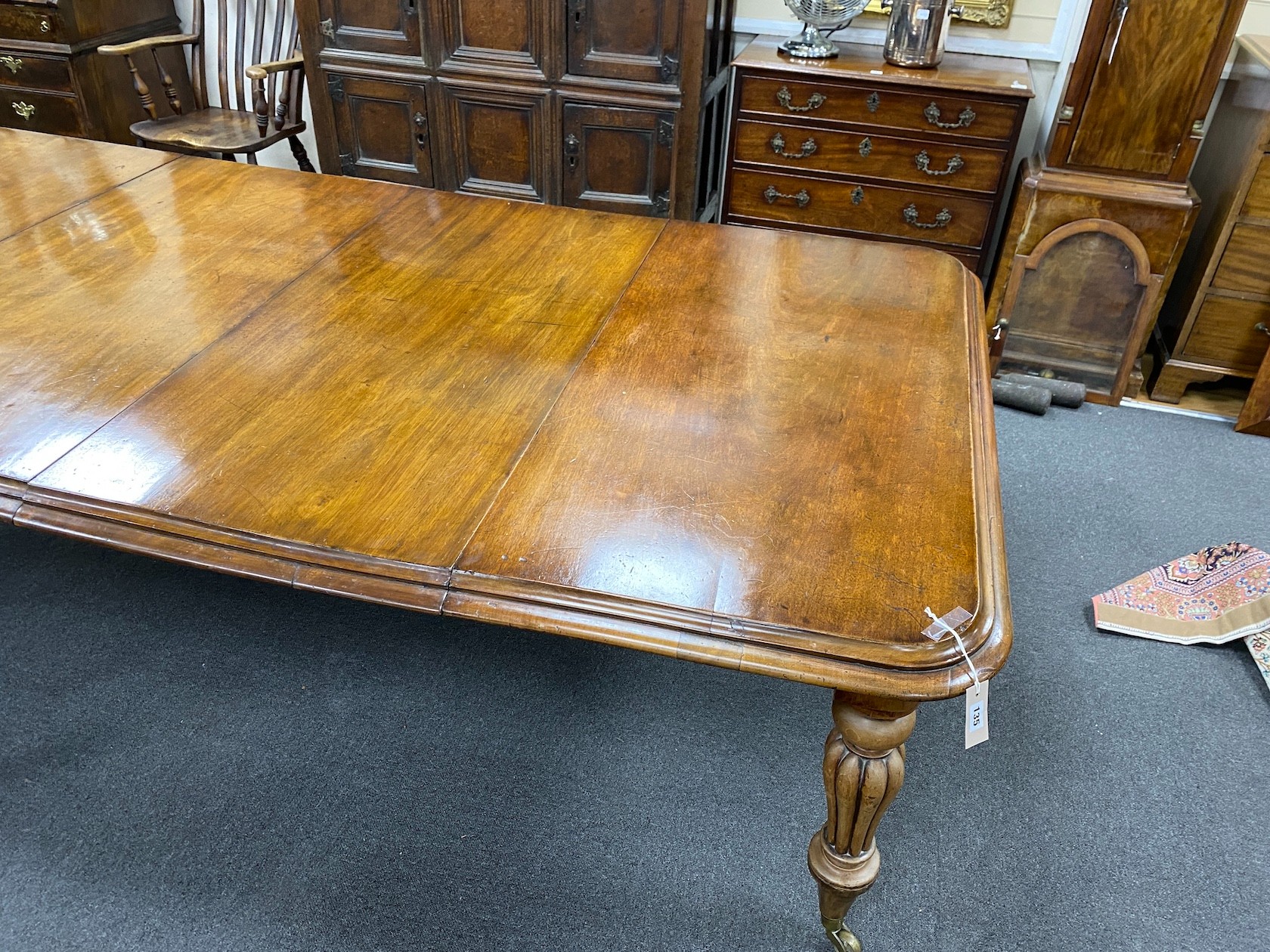 An early Victorian mahogany extending dining table on fluted baluster legs with two leaves, 240cm extended, width 120cm, height 76cm